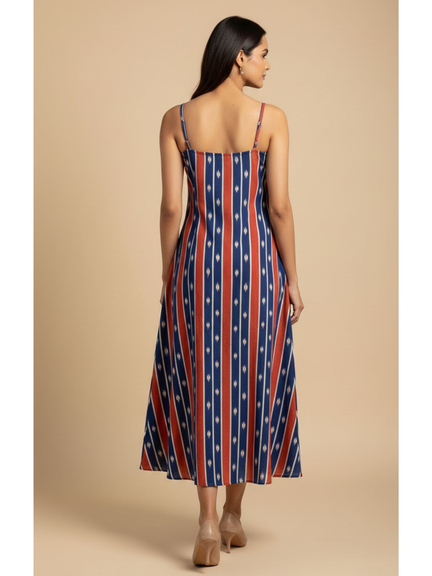 Back view of pure cotton ikat noodle strap dress featuring bold blue and red stripes, handmade craftsmanship, and a free-flowing fit.