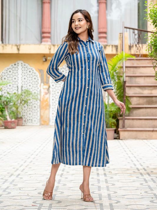 Woman wearing a blue and white striped dress standing outdoors.
