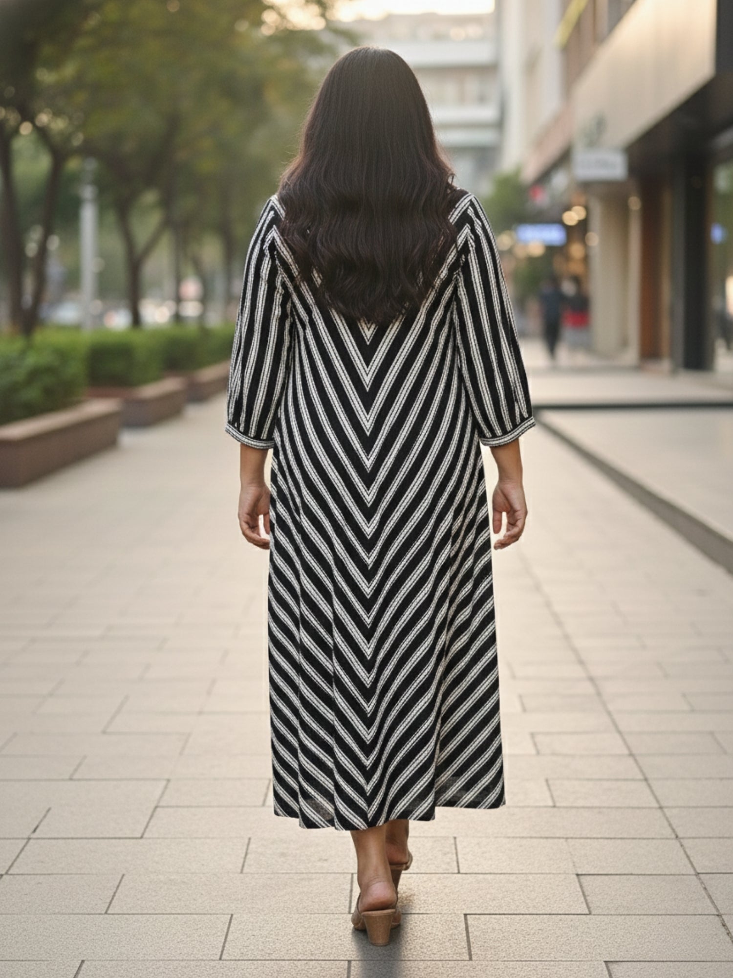 Black striped dress for women, back view, clean silhouette with vertical stripes and comfortable fall